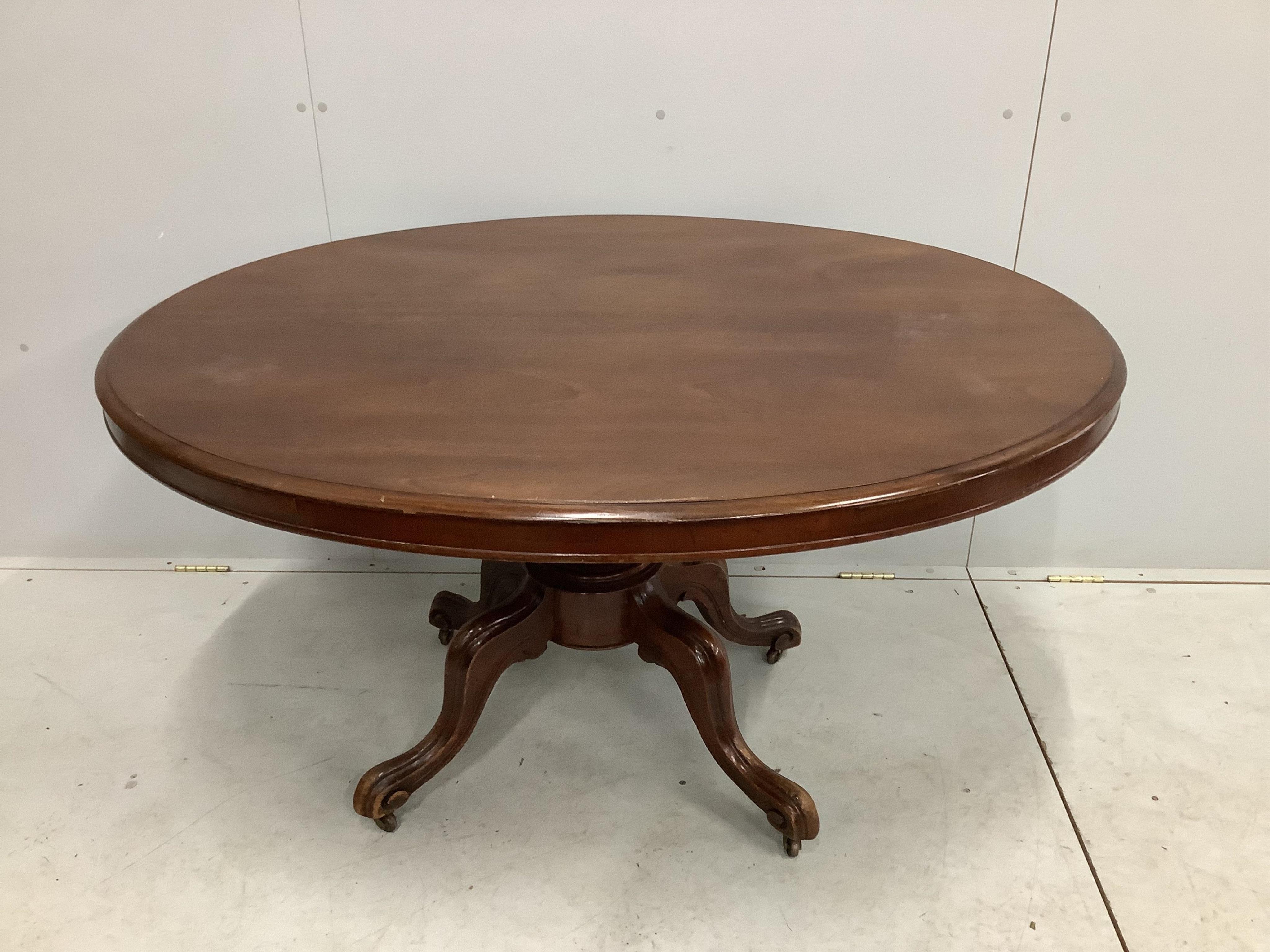 A Victorian mahogany oval tilt top breakfast table, width 135cm, depth 101cm, height 75cm. Condition - poor, some staining to the top